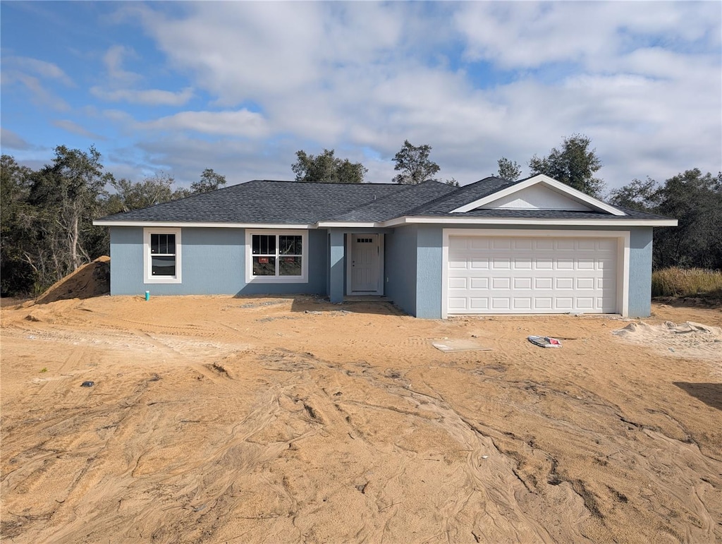 ranch-style home featuring a garage