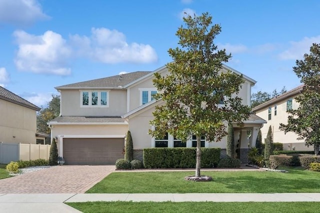 view of front of property featuring a garage and a front lawn