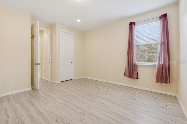 spare room with light hardwood / wood-style flooring