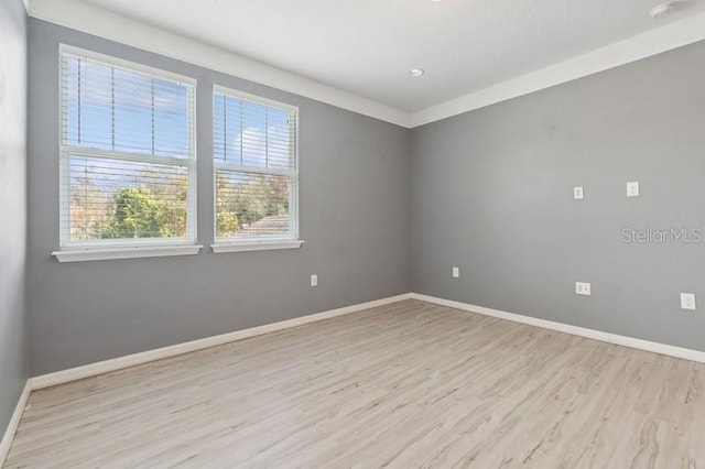 spare room with light hardwood / wood-style floors