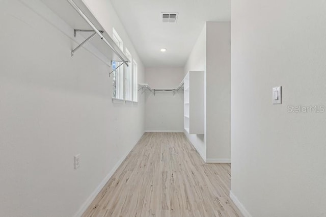 spacious closet featuring light hardwood / wood-style flooring