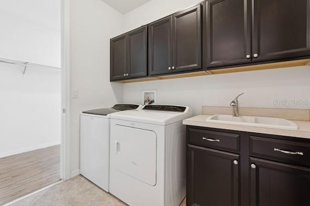 laundry area with cabinets, sink, and washing machine and clothes dryer