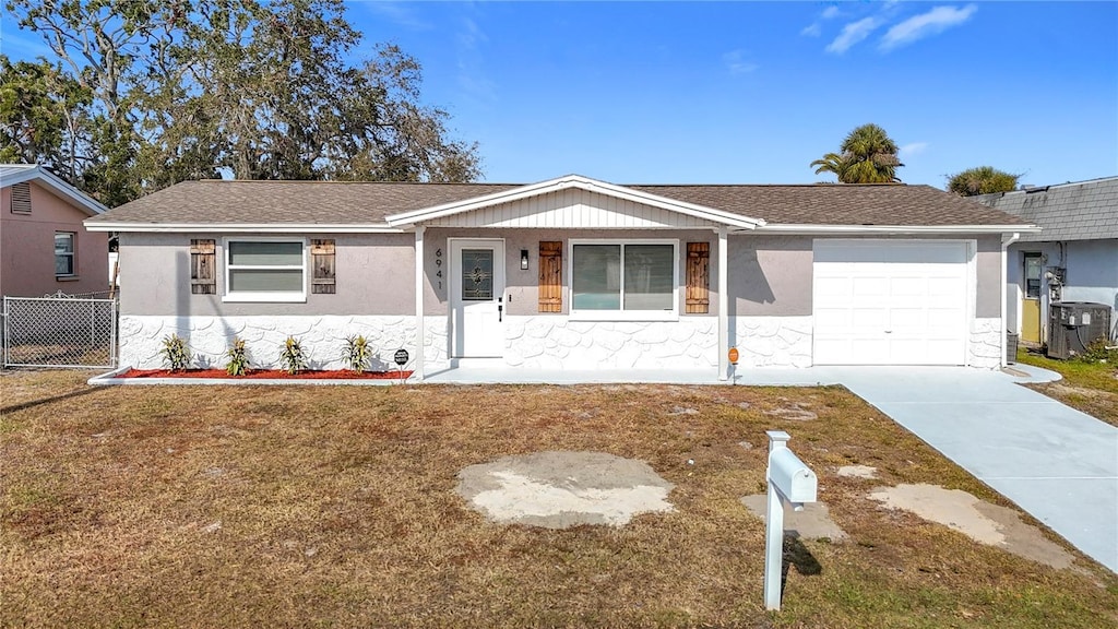 single story home featuring a front yard and a garage