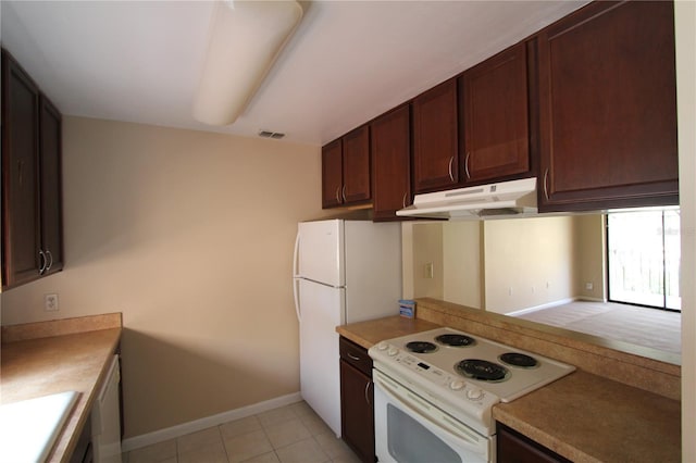 kitchen featuring white appliances and light tile patterned floors