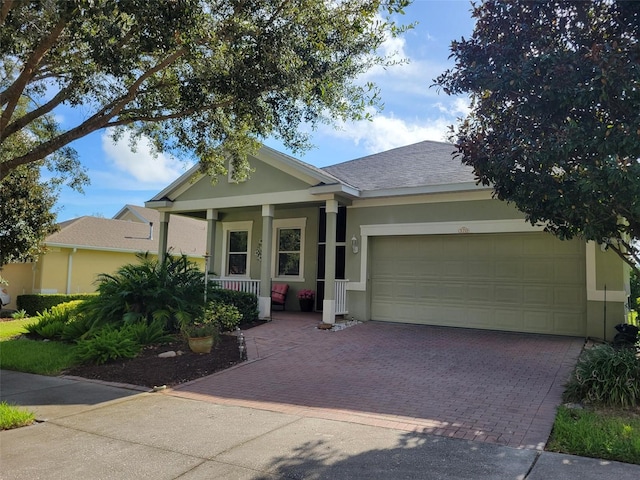 view of front facade featuring a garage and covered porch