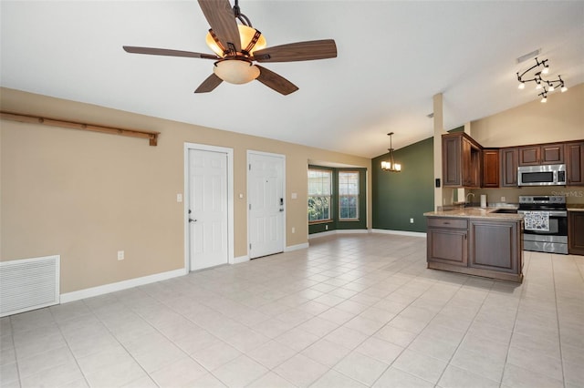 kitchen featuring vaulted ceiling, light tile patterned floors, ceiling fan with notable chandelier, appliances with stainless steel finishes, and dark brown cabinetry