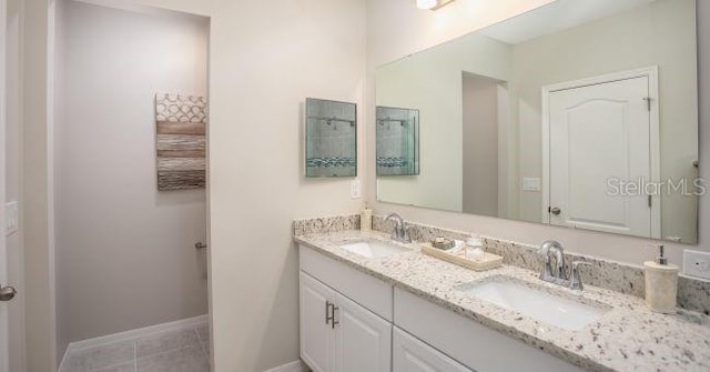 33 Pine Grove Dr, Palm Coast, FL 32164 - full bath with double vanity, tile patterned floors, and baseboards