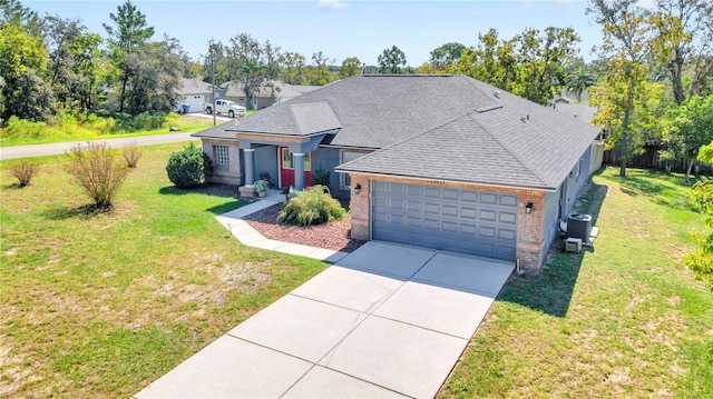 view of front of home featuring a garage, central AC unit, and a front lawn