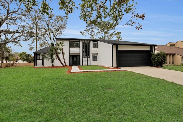 view of front of property with a front yard and a garage