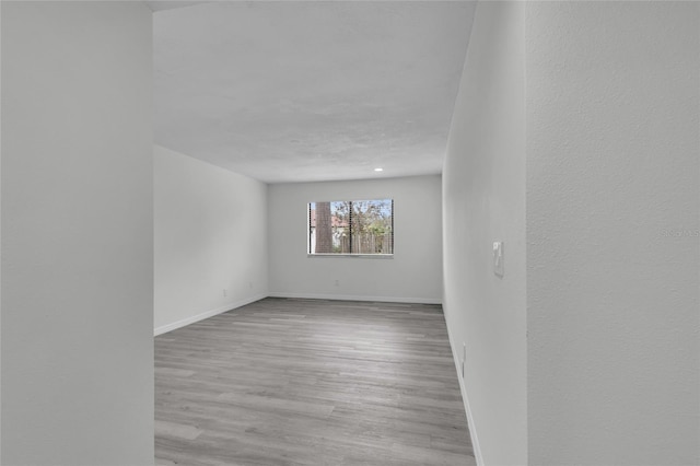 unfurnished room with light wood-type flooring