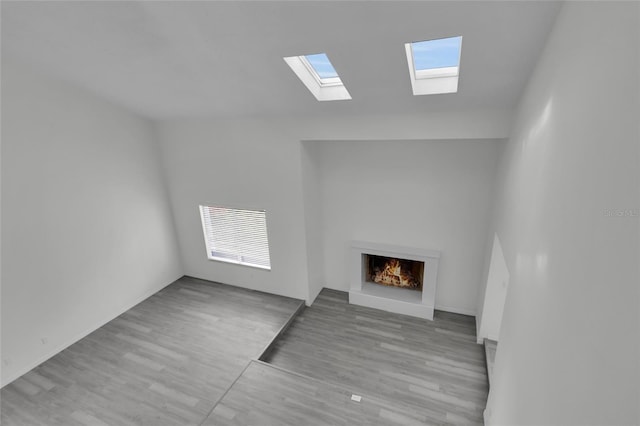 unfurnished living room featuring lofted ceiling