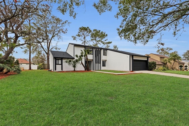 view of front of home with a front lawn and a garage