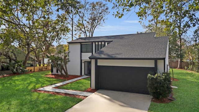 view of front of house with a front yard and a garage