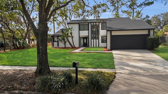 view of front of house with a front lawn and a garage