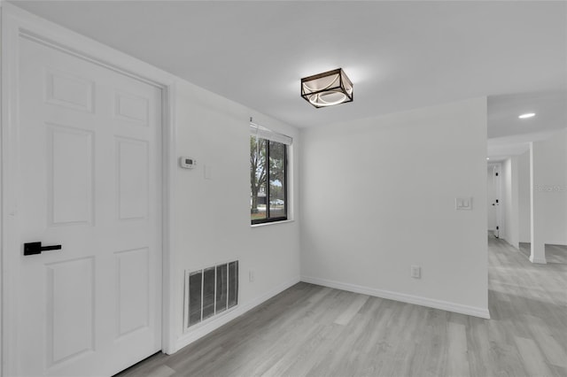 spare room featuring light wood-type flooring