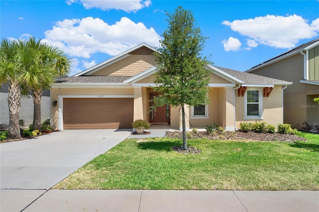 view of front of home with a front yard and a garage