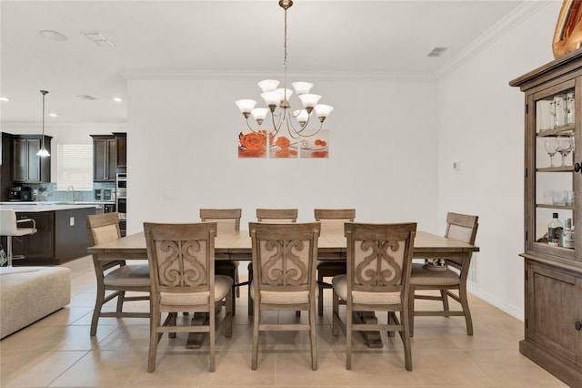 tiled dining space featuring ornamental molding, a chandelier, and sink