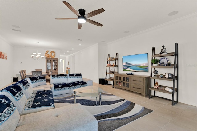 tiled living room with ceiling fan with notable chandelier and ornamental molding