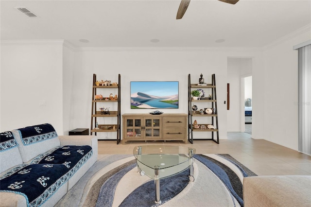 tiled living room with ceiling fan and crown molding