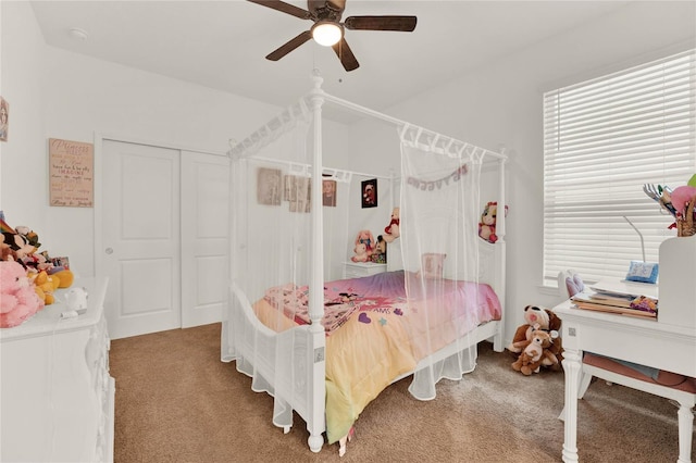 bedroom with ceiling fan, multiple windows, and carpet floors