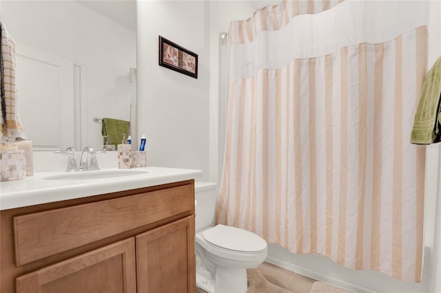 full bathroom with tile patterned flooring, shower / tub combo with curtain, vanity, and toilet