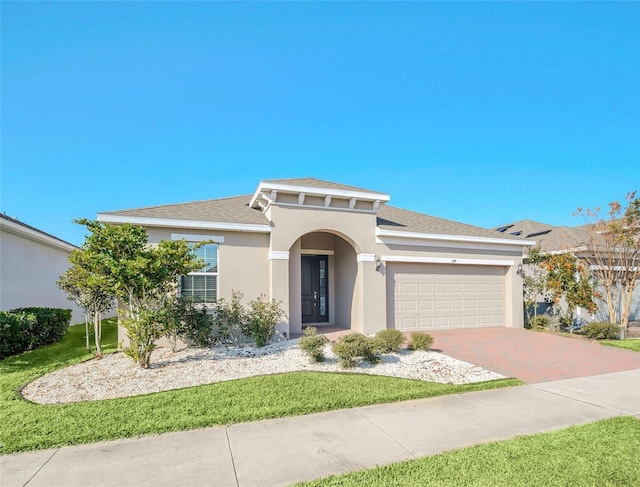 view of front of house with a front yard and a garage