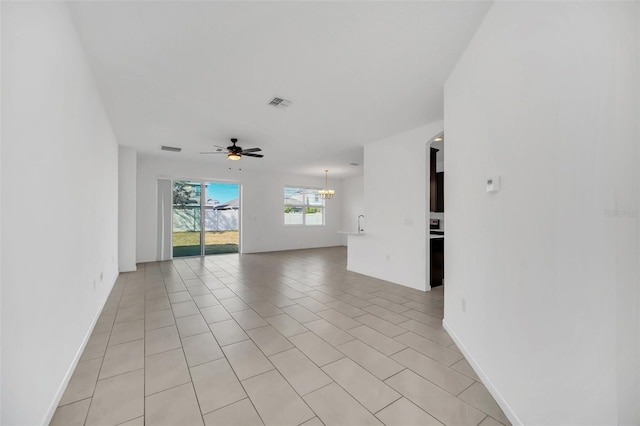 tiled spare room featuring ceiling fan