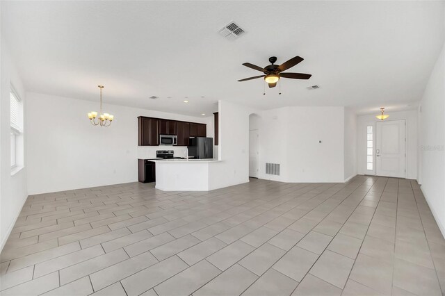 unfurnished living room with ceiling fan with notable chandelier and light tile patterned floors