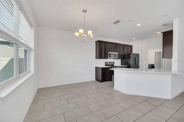 kitchen featuring stainless steel appliances, light tile patterned floors, an inviting chandelier, dark brown cabinets, and sink