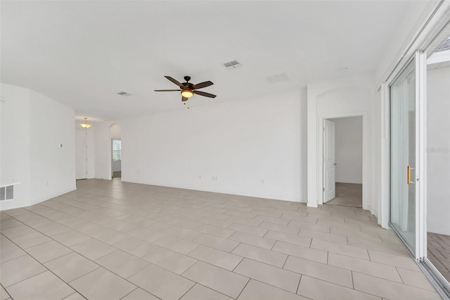 tiled spare room with ceiling fan