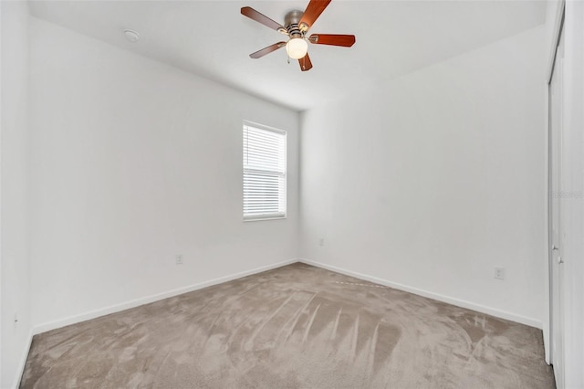 carpeted empty room featuring ceiling fan