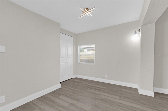 spare room with hardwood / wood-style floors