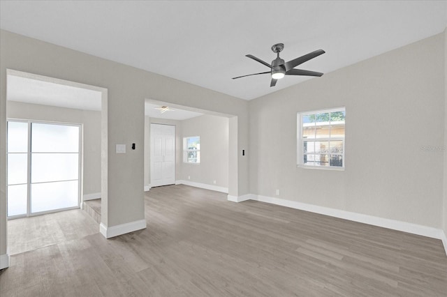 unfurnished room with ceiling fan, lofted ceiling, and light hardwood / wood-style flooring