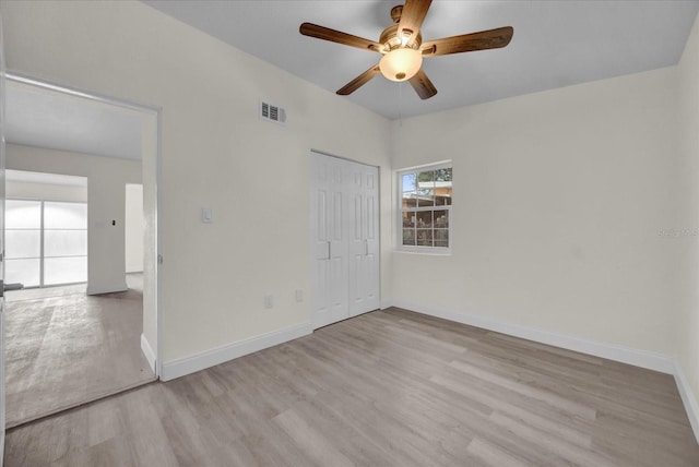 spare room with ceiling fan and light hardwood / wood-style floors