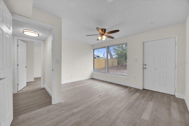 interior space featuring ceiling fan and light wood-type flooring