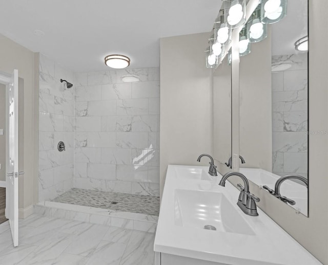 bathroom featuring a tile shower and vanity