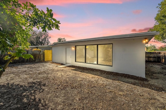 view of back house at dusk