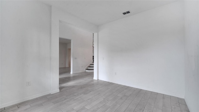 unfurnished room with light hardwood / wood-style floors