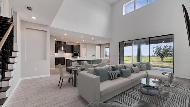 living room with a high ceiling and sink