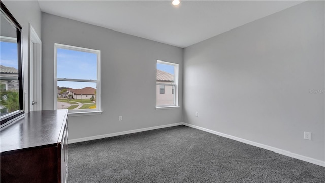 carpeted empty room with plenty of natural light