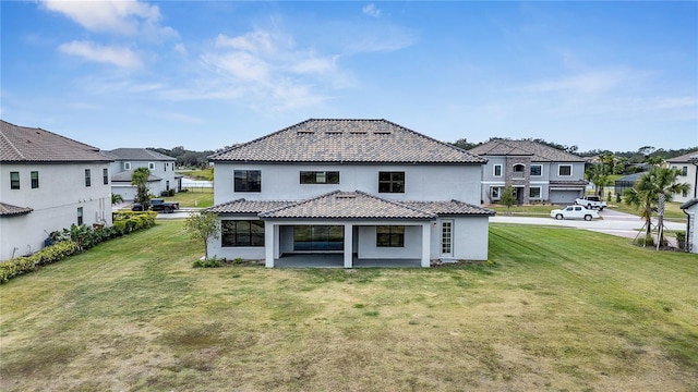 back of house featuring a yard and a patio