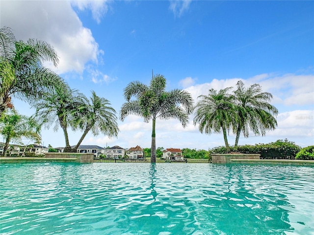 view of pool featuring a water view