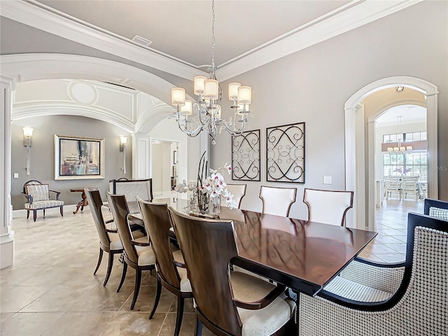 tiled dining area with a notable chandelier and ornamental molding