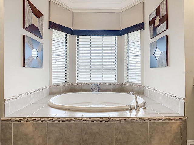 bathroom featuring ornamental molding, a wealth of natural light, and tiled bath