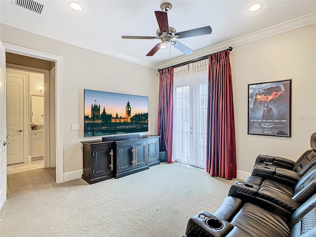 living room with light colored carpet, ceiling fan, and crown molding