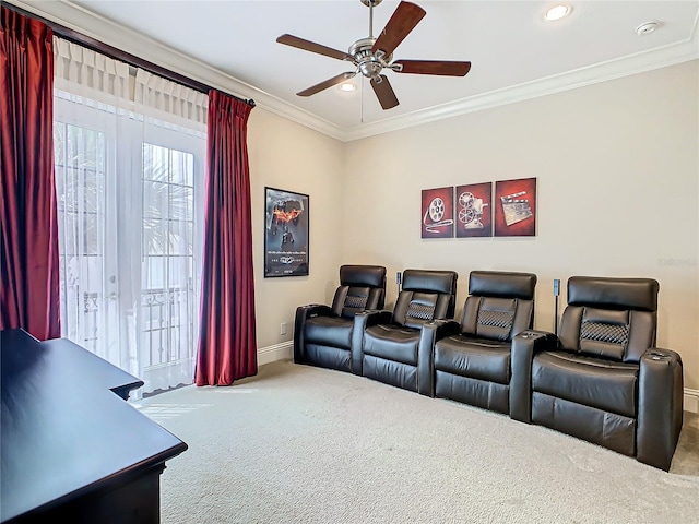 cinema room with ceiling fan, ornamental molding, and carpet flooring