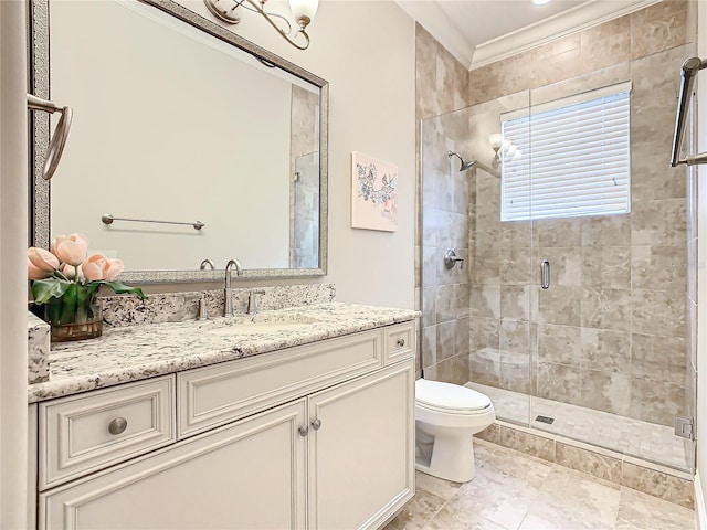 bathroom featuring toilet, a shower with door, vanity, and ornamental molding