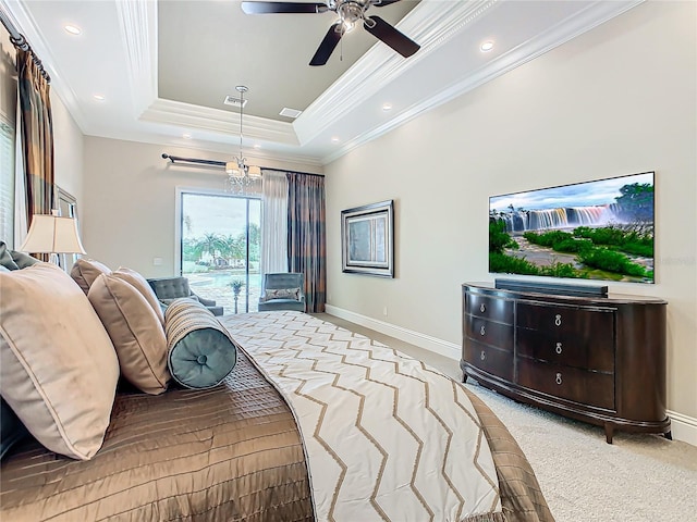 carpeted bedroom featuring access to outside, crown molding, ceiling fan with notable chandelier, and a tray ceiling