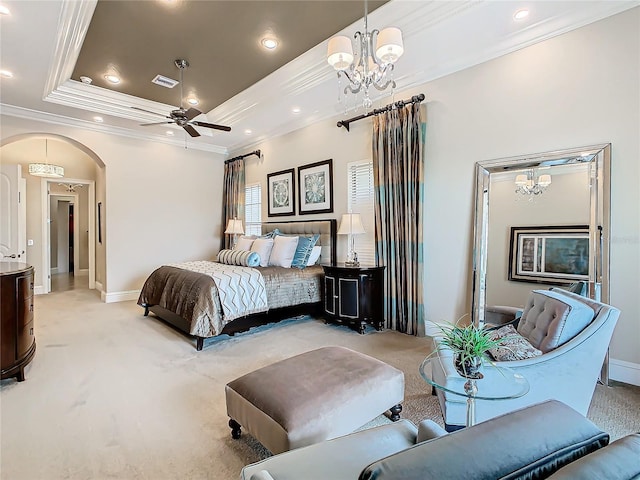 carpeted bedroom with a raised ceiling, ornamental molding, and a notable chandelier