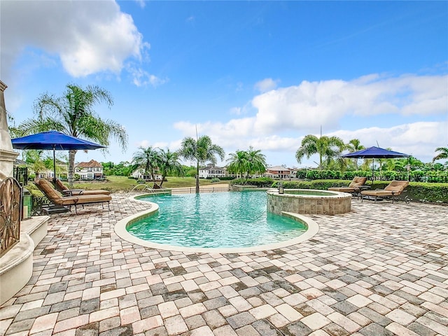 view of swimming pool featuring an in ground hot tub and a patio